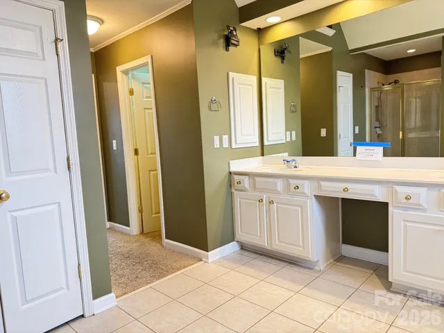 a spacious bathroom with a mirror sink and a shower