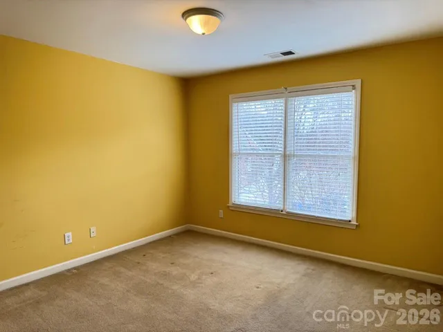 an empty room with a empty space and a window