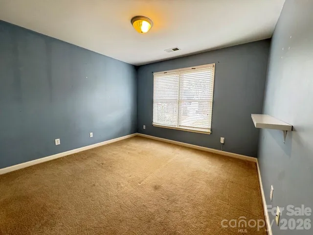 an empty room with a empty space and a window