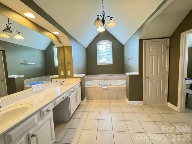 a view of kitchen with stainless steel appliances kitchen island granite countertop a sink and a refrigerator