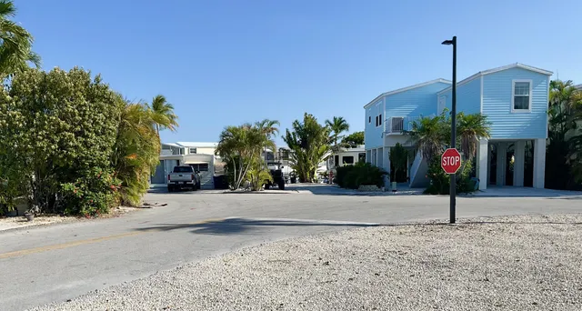 a street sign on a road next to a building