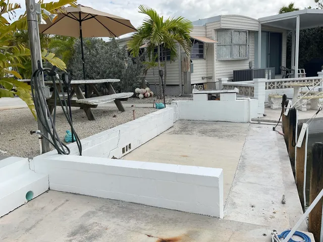 a view of outdoor kitchen outdoor dining space and swimming pool