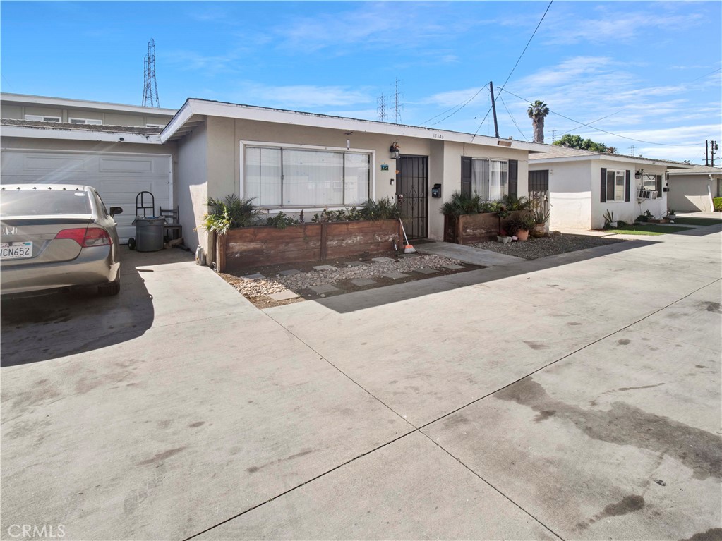16840 Passage Paramount Ca Paramount, CA 90723 - Photo 5 of 16 a view of a white house with a outdoor space