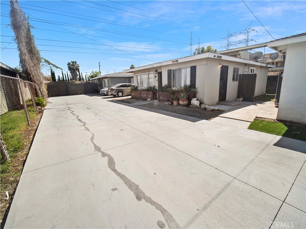 16840 Passage Paramount Ca Paramount, CA 90723 - Photo 9 of 16 a view of a white house with wooden fence