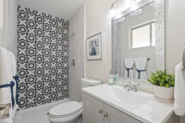 a bathroom with a sink toilet and mirror