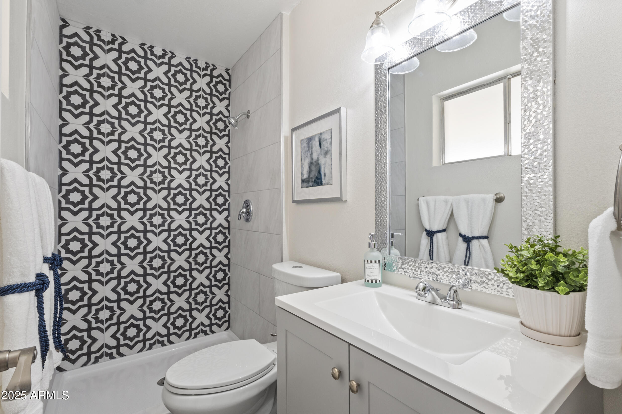 3339 West Shaw Butte Drive Phoenix, AZ 85029 - Photo 11 of 16 a bathroom with a sink toilet and mirror