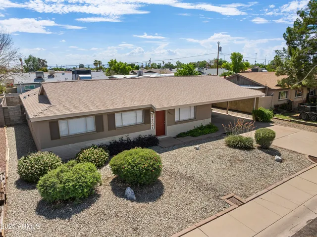 an aerial view of a house with a yard and potted plants