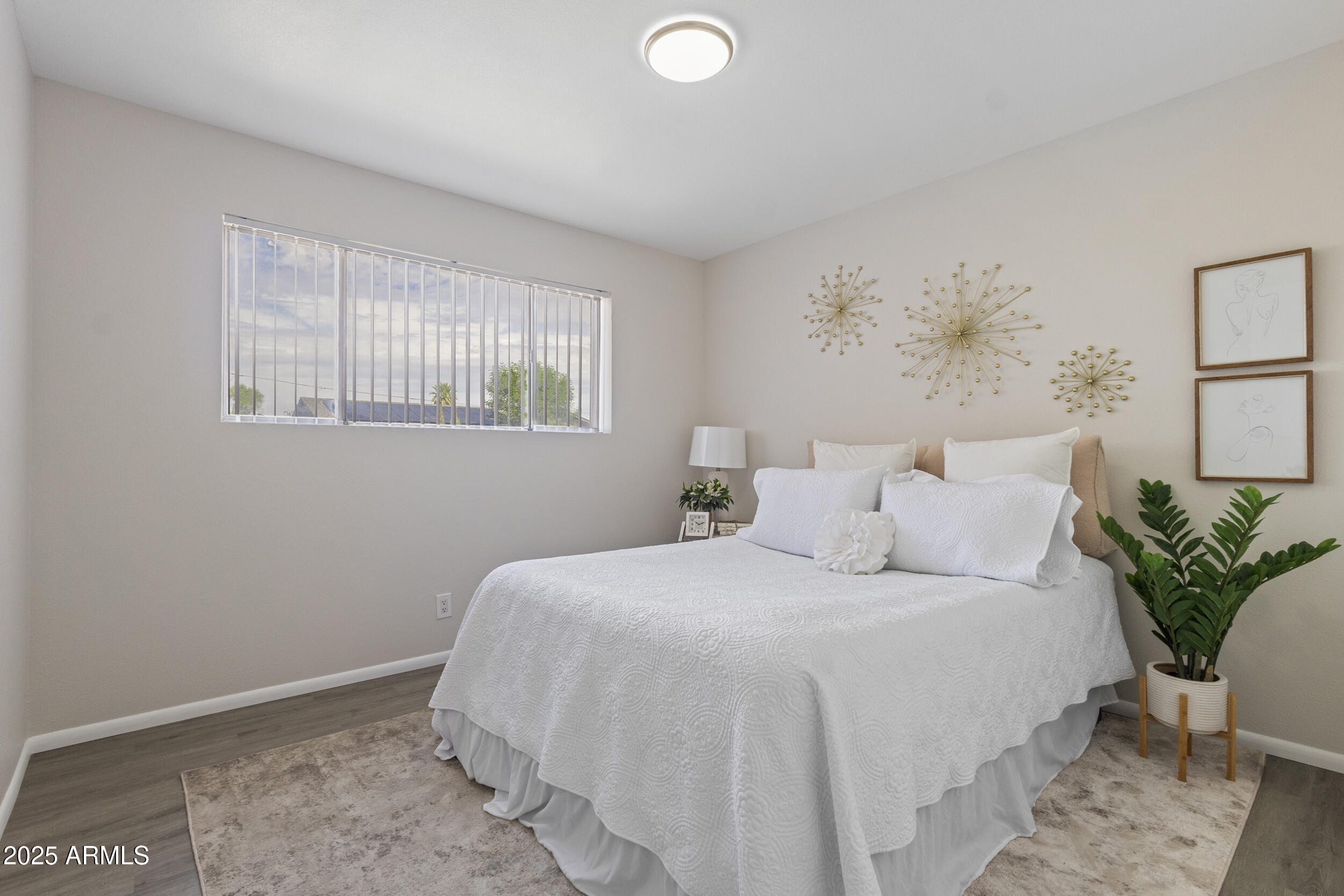 3339 West Shaw Butte Drive Phoenix, AZ 85029 - Photo 10 of 16 a bedroom with a large bed and a window