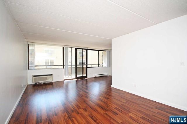 555 Gorge Road, Unit 3B Cliffside Park, NJ 07010 - Photo 2 of 11 a view of an empty room with a window and wooden floor
