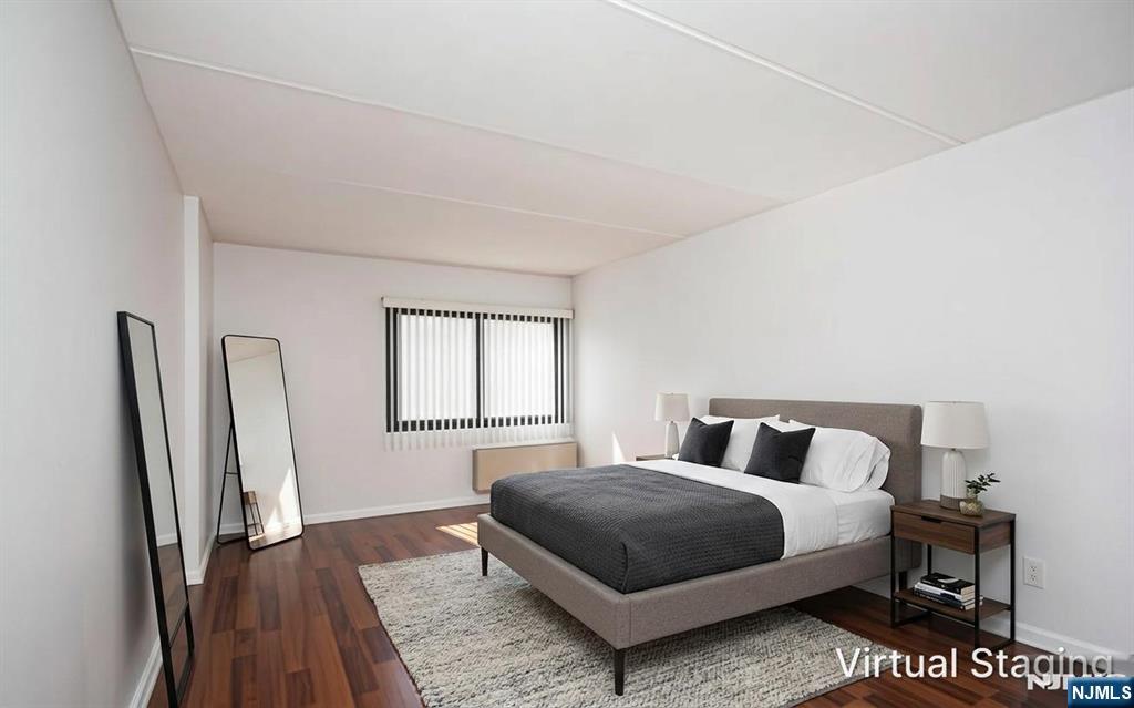 555 Gorge Road, Unit 3B Cliffside Park, NJ 07010 - Photo 4 of 14 a bedroom with a bed lamp and a large window