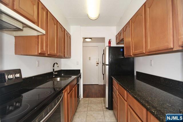 555 Gorge Road, Unit 3B Cliffside Park, NJ 07010 - Photo 7 of 14 a kitchen with a sink a stove and refrigerator