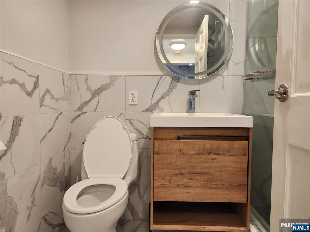 555 Gorge Road, Unit 3B Cliffside Park, NJ 07010 - Photo 8 of 11 a bathroom with a toilet a sink and mirror