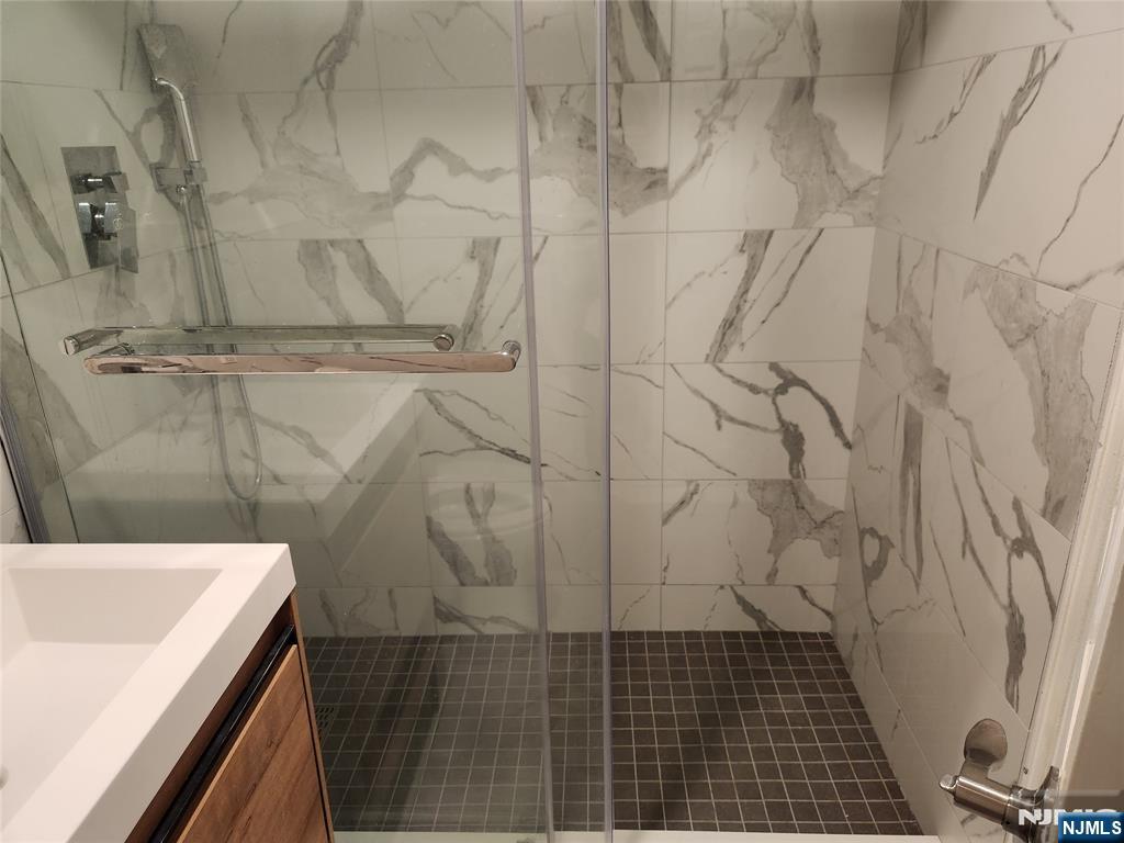 555 Gorge Road, Unit 3B Cliffside Park, NJ 07010 - Photo 9 of 11 a bathroom with a sink and a shower