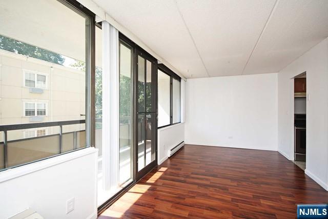 555 Gorge Road, Unit 3B Cliffside Park, NJ 07010 - Photo 9 of 14 a view of an empty room with wooden floor and a window