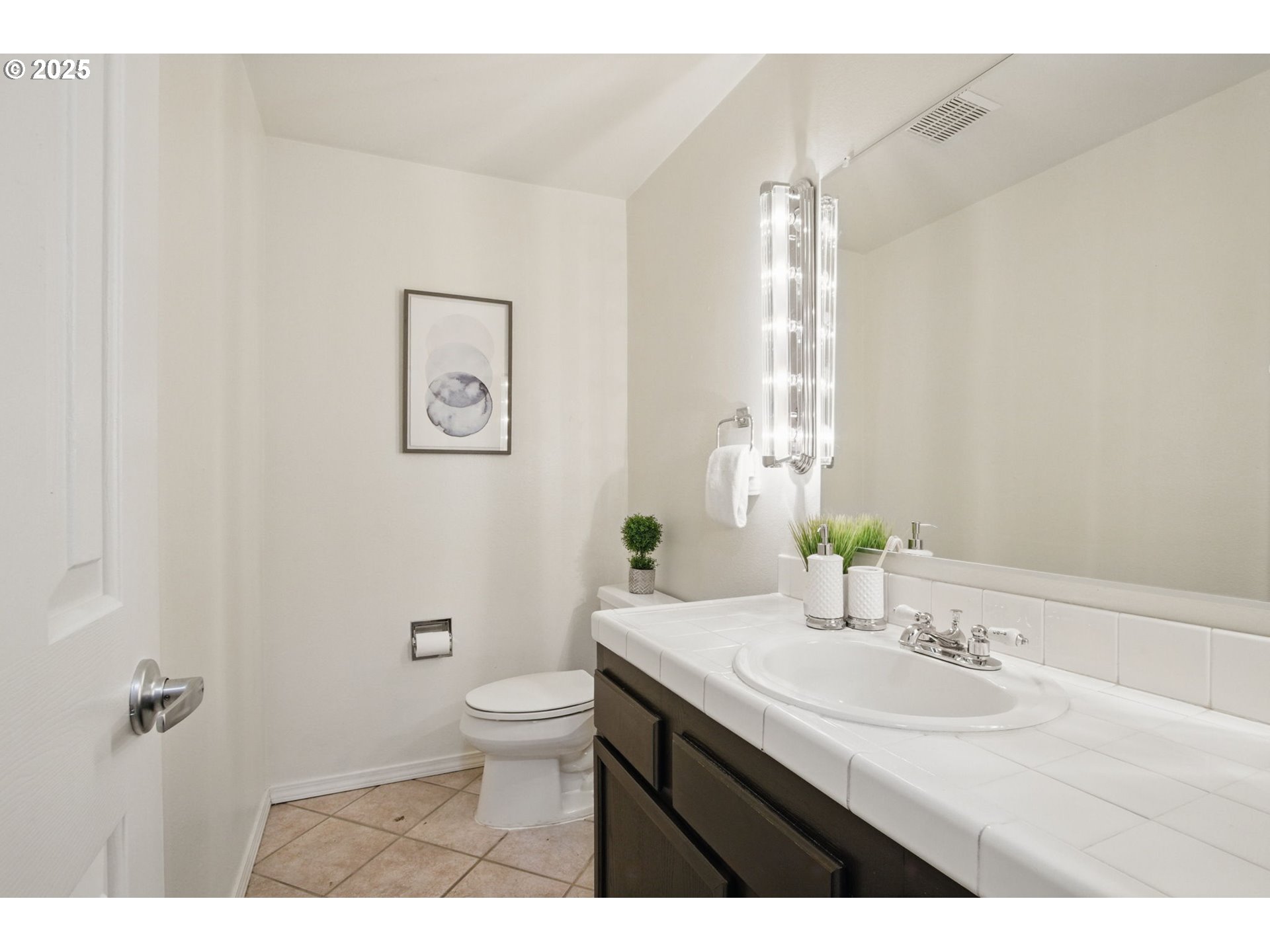 29460 Southwest Volley Street, Unit 67 Wilsonville, OR 97070 - Photo 12 of 24 a bathroom with a granite countertop sink a toilet and a mirror