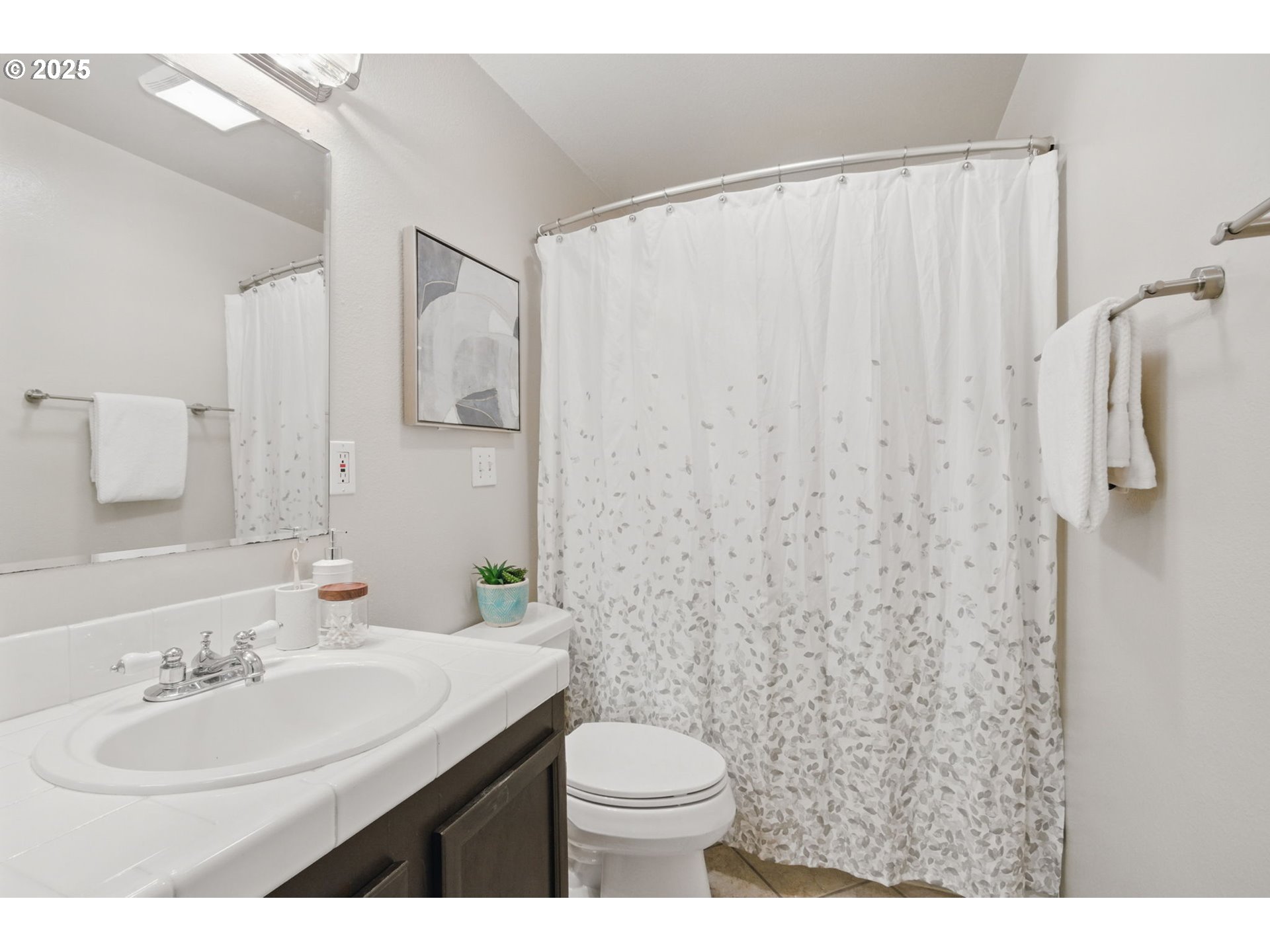29460 Southwest Volley Street, Unit 67 Wilsonville, OR 97070 - Photo 14 of 24 a bathroom with a sink a toilet and shower curtain