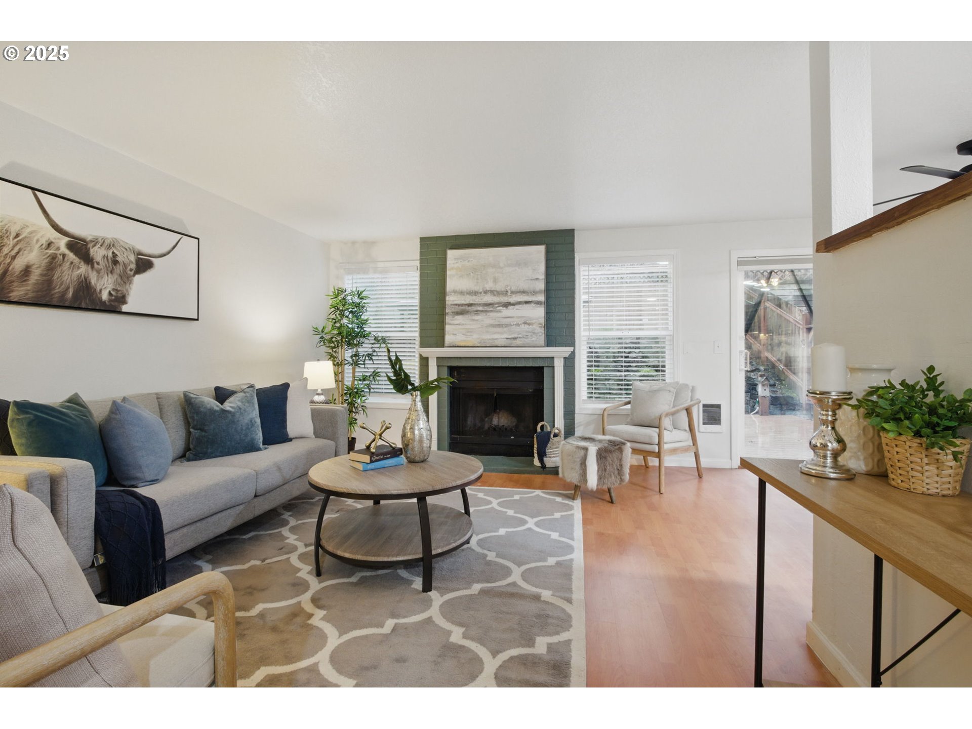 29460 Southwest Volley Street, Unit 67 Wilsonville, OR 97070 - Photo 3 of 24 a living room with furniture a fireplace and a large window