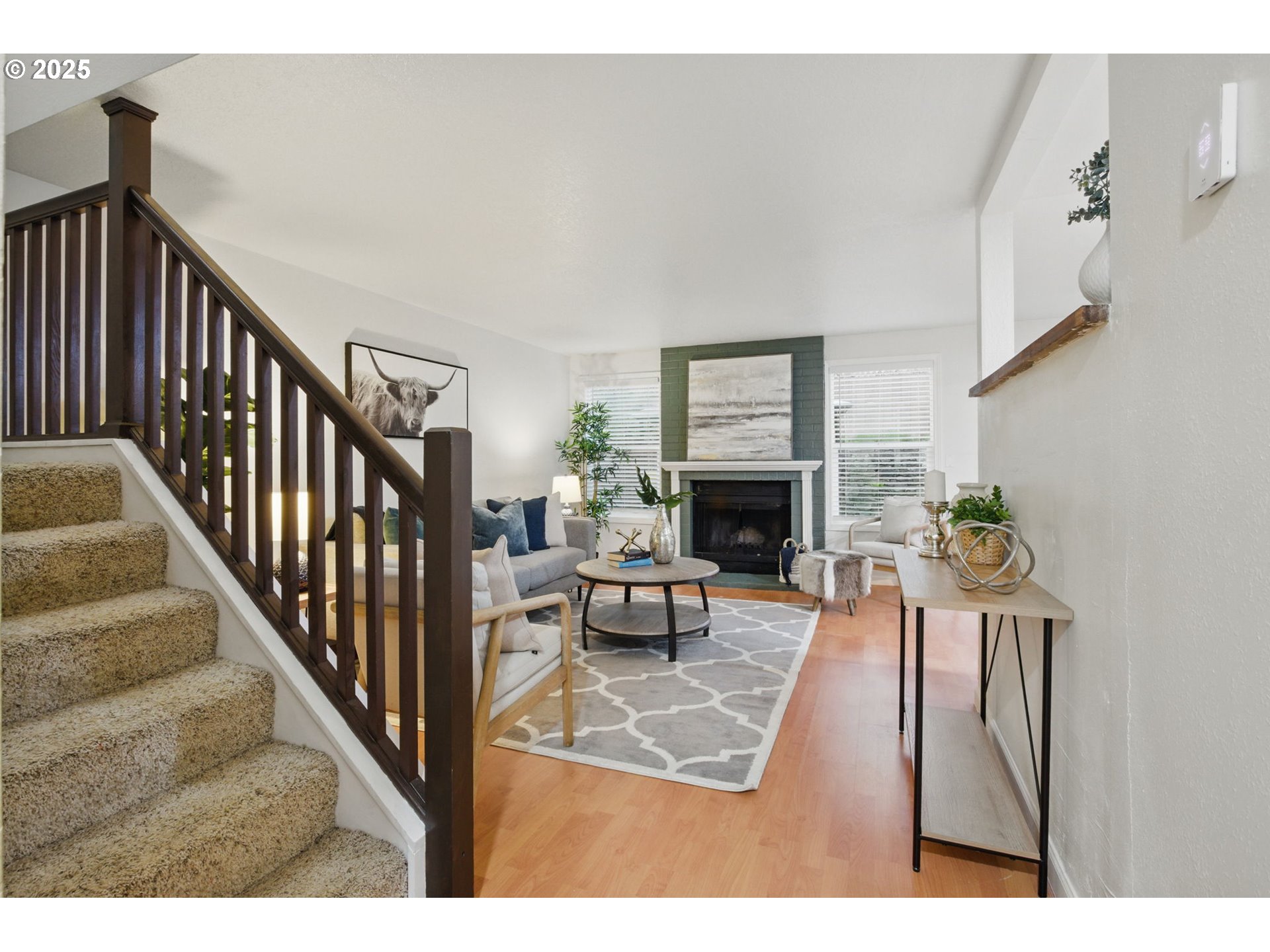 29460 Southwest Volley Street, Unit 67 Wilsonville, OR 97070 - Photo 8 of 24 a view of a livingroom with furniture hardwood floor and a fireplace