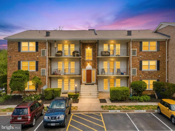 a front view of a residential apartment building with a yard