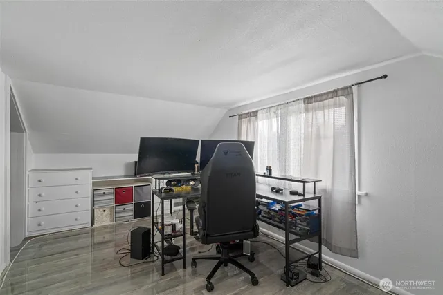 a view of a bedroom with a window and furniture