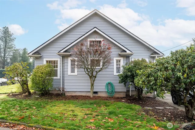 a backyard of a house with table and chairs