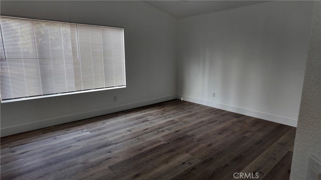 21484 Dickinson Road Moreno Valley, CA 92557 - Photo 8 of 10 a view of an empty room with wooden floor and a window