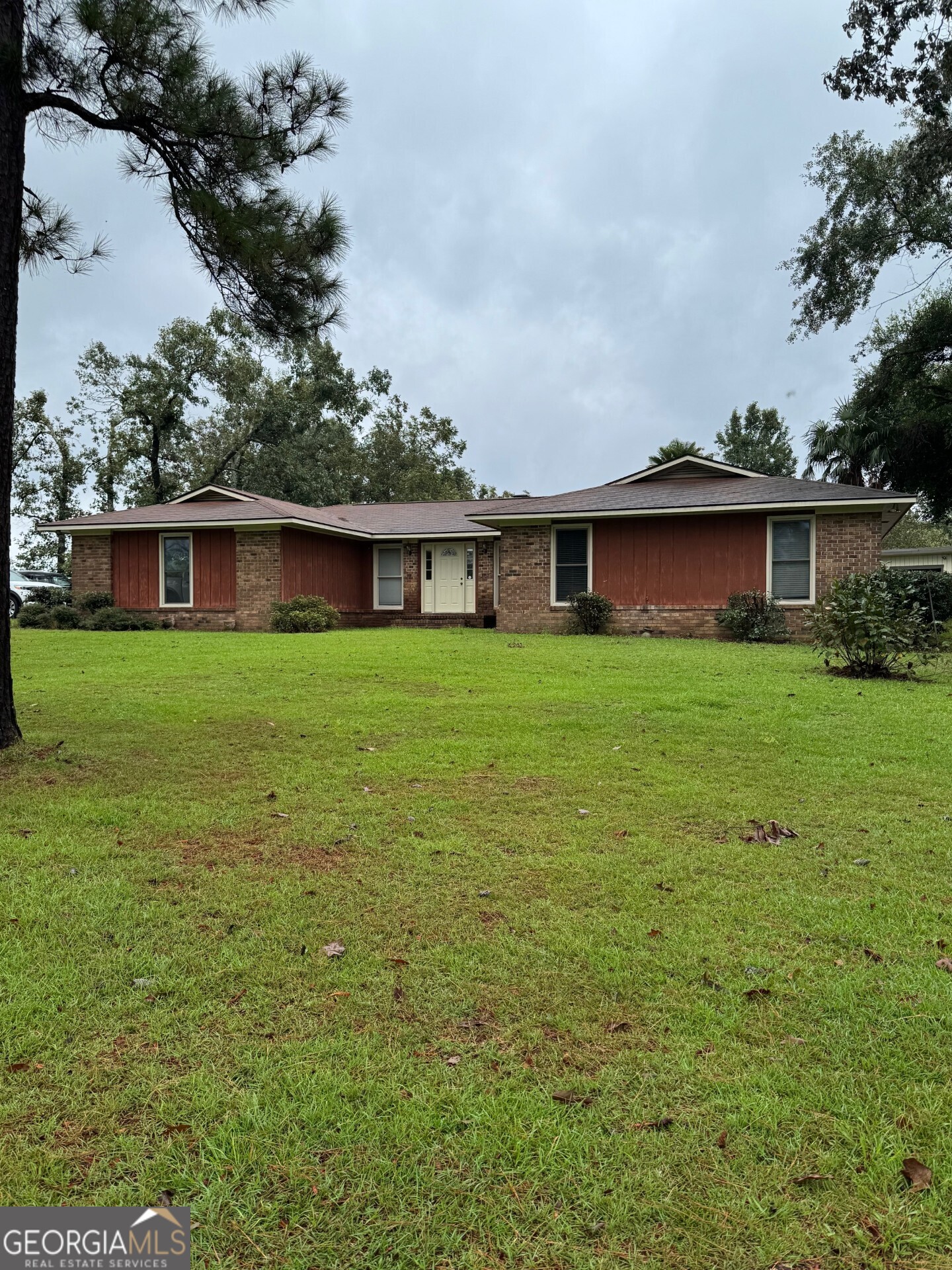 a view of a house with a yard and sitting area