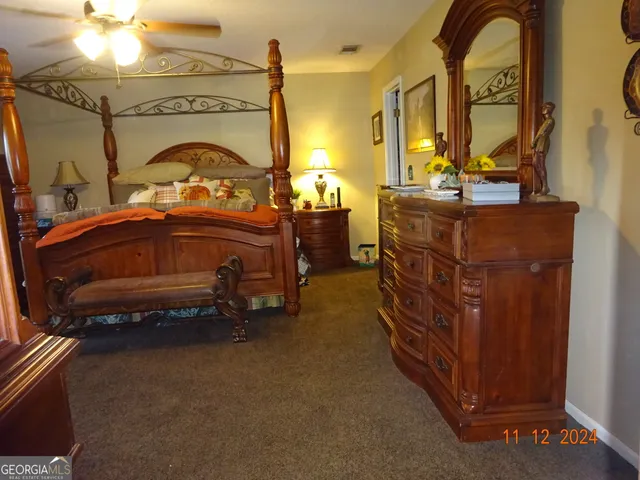 a bedroom with a bed and a mirror