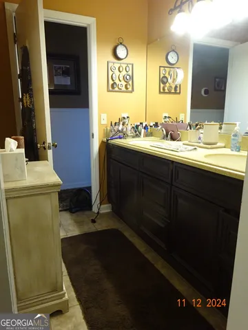 a bathroom with a sink toilet and mirror