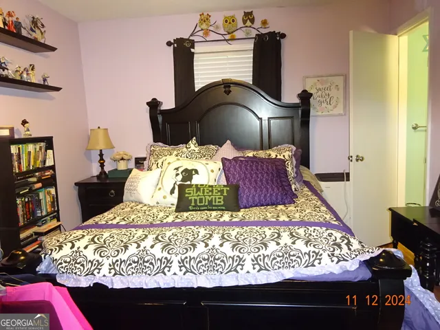 a bed sitting in a bedroom next to a window