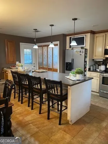 a dining table chairs wooden floor and kitchen view