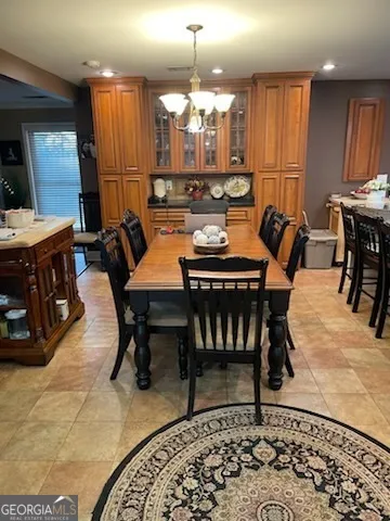 a view of a a dining room with furniture window and wooden floor