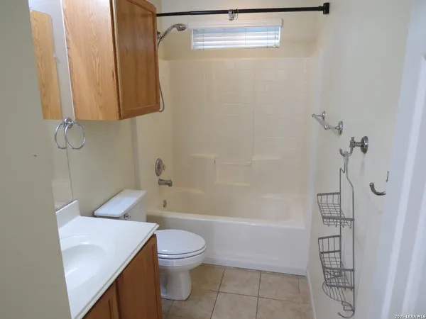 a bathroom with a shower a toilet and sink