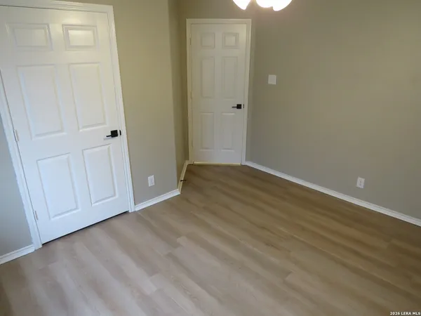 a view of an empty room with closet area