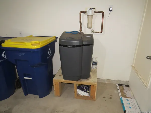 view of a room with water heater and shelf