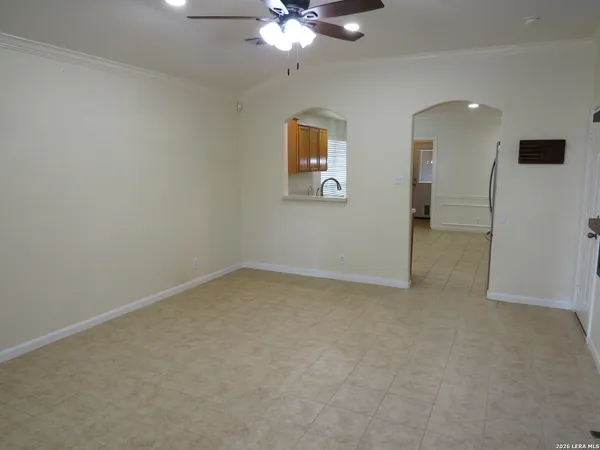 an empty room with a ceiling fan and a window