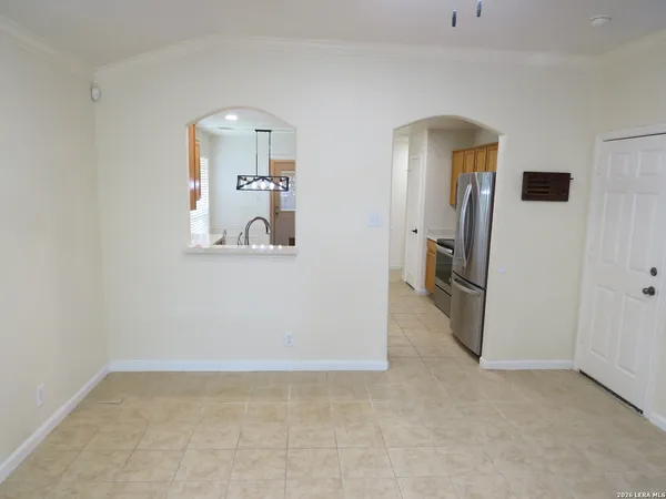a view of a hallway with wooden floor and a living room
