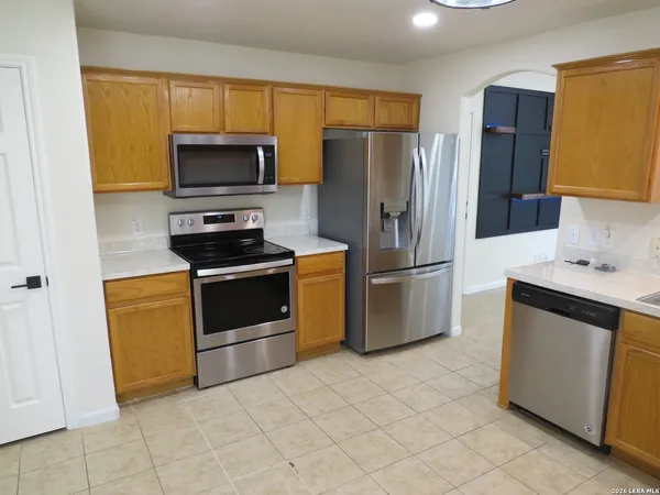 a kitchen with stainless steel appliances a refrigerator stove and microwave