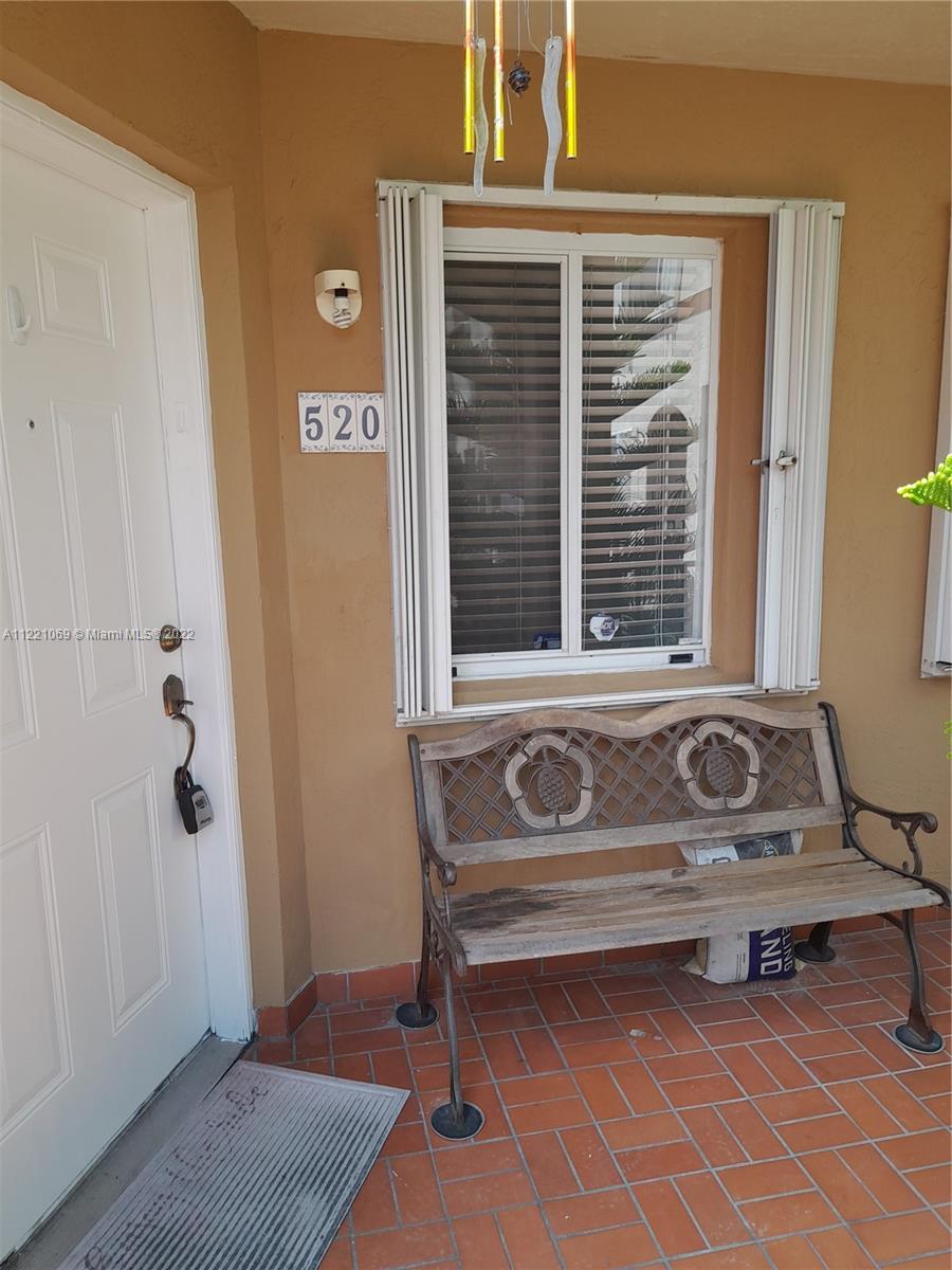 a bench sitting in front of a door