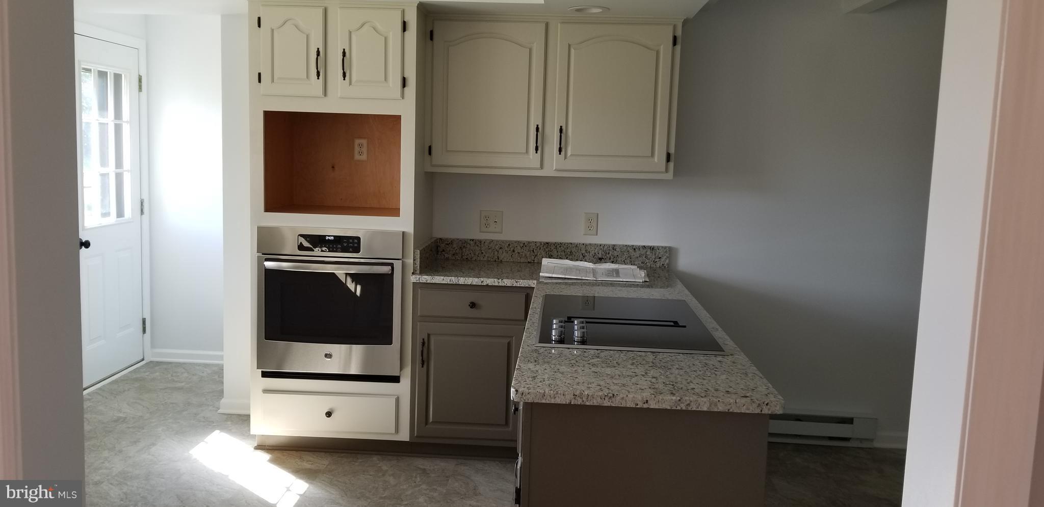 15515 Broadfording Road Clear Spring, MD 21722 - Photo 3 of 19 a kitchen with granite countertop a stove and a sink