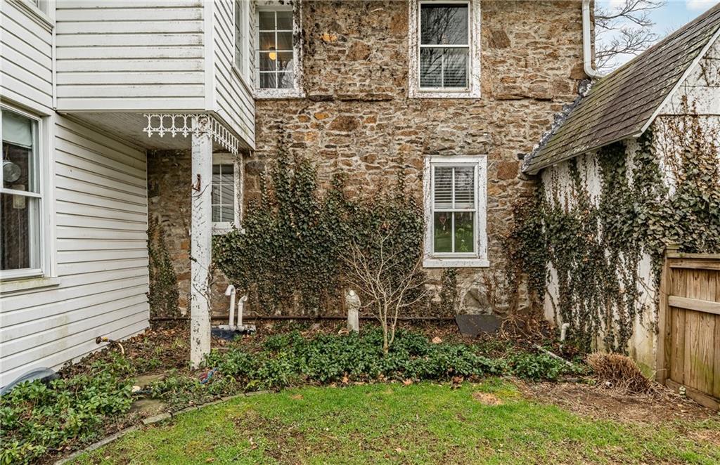 701 Oakbourne Road West Chester, PA 19382 - Photo 46 of 50 a view of a house with brick walls and a yard with plants
