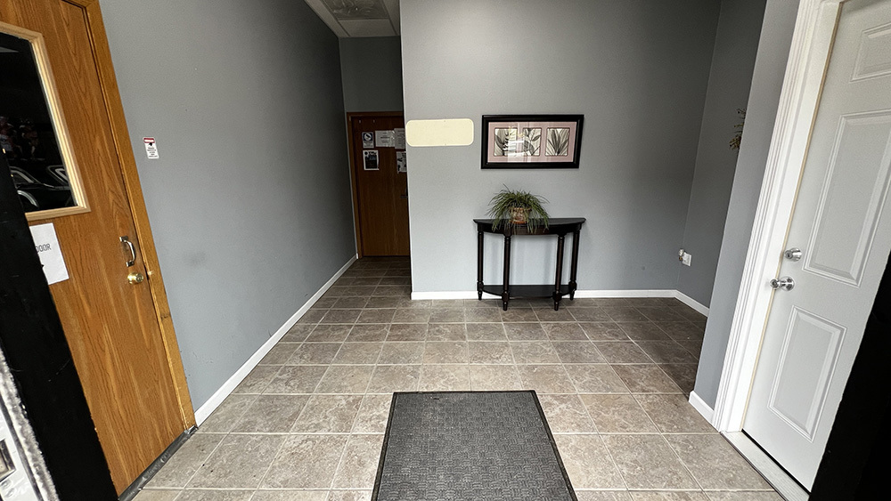 222 West Main Street Morrison, IL 61270 - Photo 4 of 21 a view of a hallway with wooden floor and a bathroom