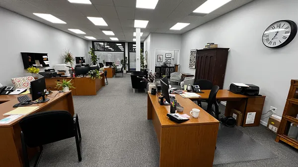 a living room with furniture gym equipment and a large window