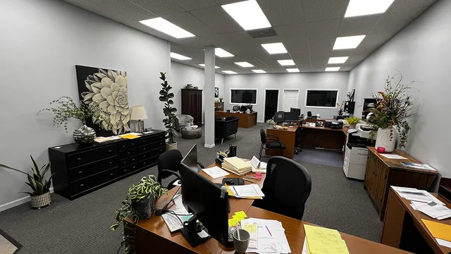 a view of a workspace with furniture and wooden floor