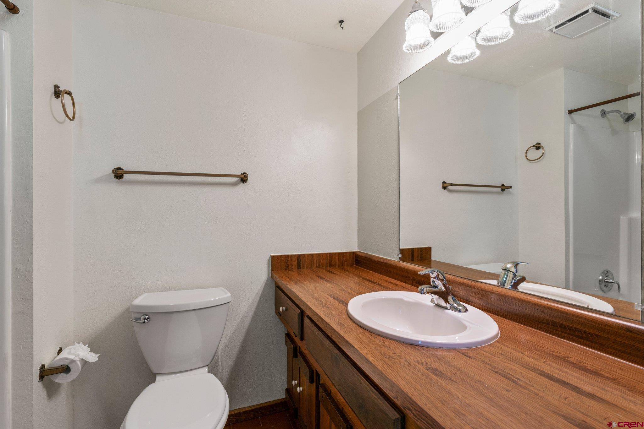 340 Ridge Road Durango, CO 81303 - Photo 15 of 35 a bathroom with a granite countertop toilet a sink and a mirror