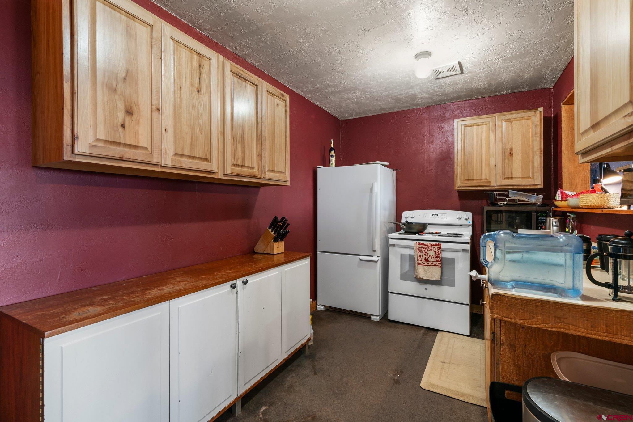 340 Ridge Road Durango, CO 81303 - Photo 22 of 35 a kitchen with refrigerator and cabinets