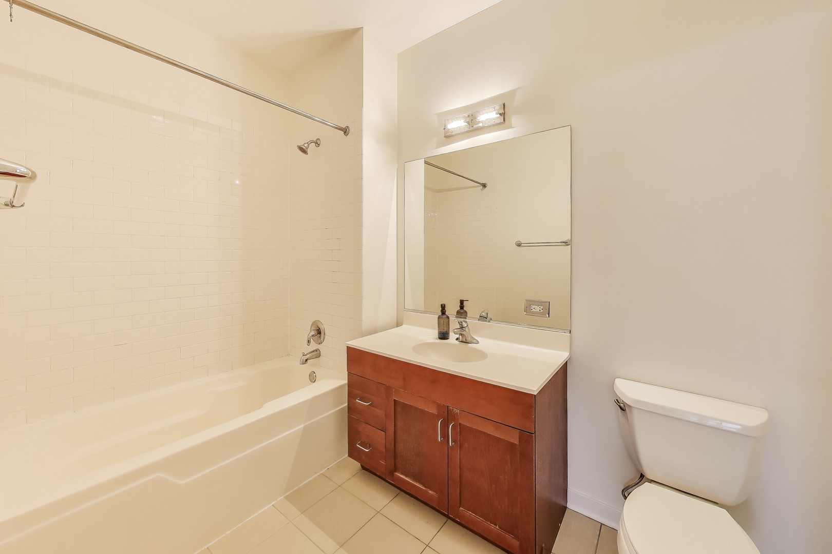 1155 West Roosevelt Road, Unit 412 Chicago, IL 60608 - Photo 27 of 31 a bathroom with a sink a toilet and shower