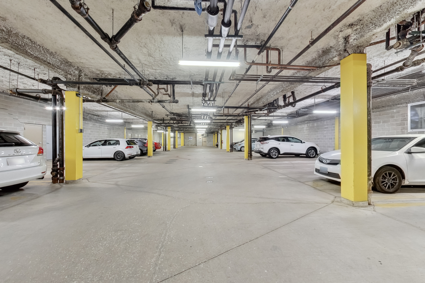 1155 West Roosevelt Road, Unit 412 Chicago, IL 60608 - Photo 30 of 31 a view of parking garage with cars