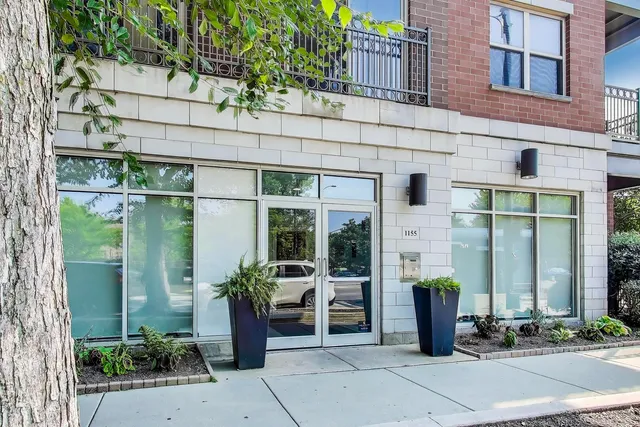 a front view of a building with potted plants