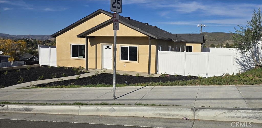 237 East Prospect Street Lake Elsinore, CA 92530 - Photo 1 of 1 a front view of a house with a yard